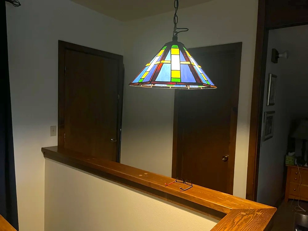 Blue geometric pendant lamp installed in room